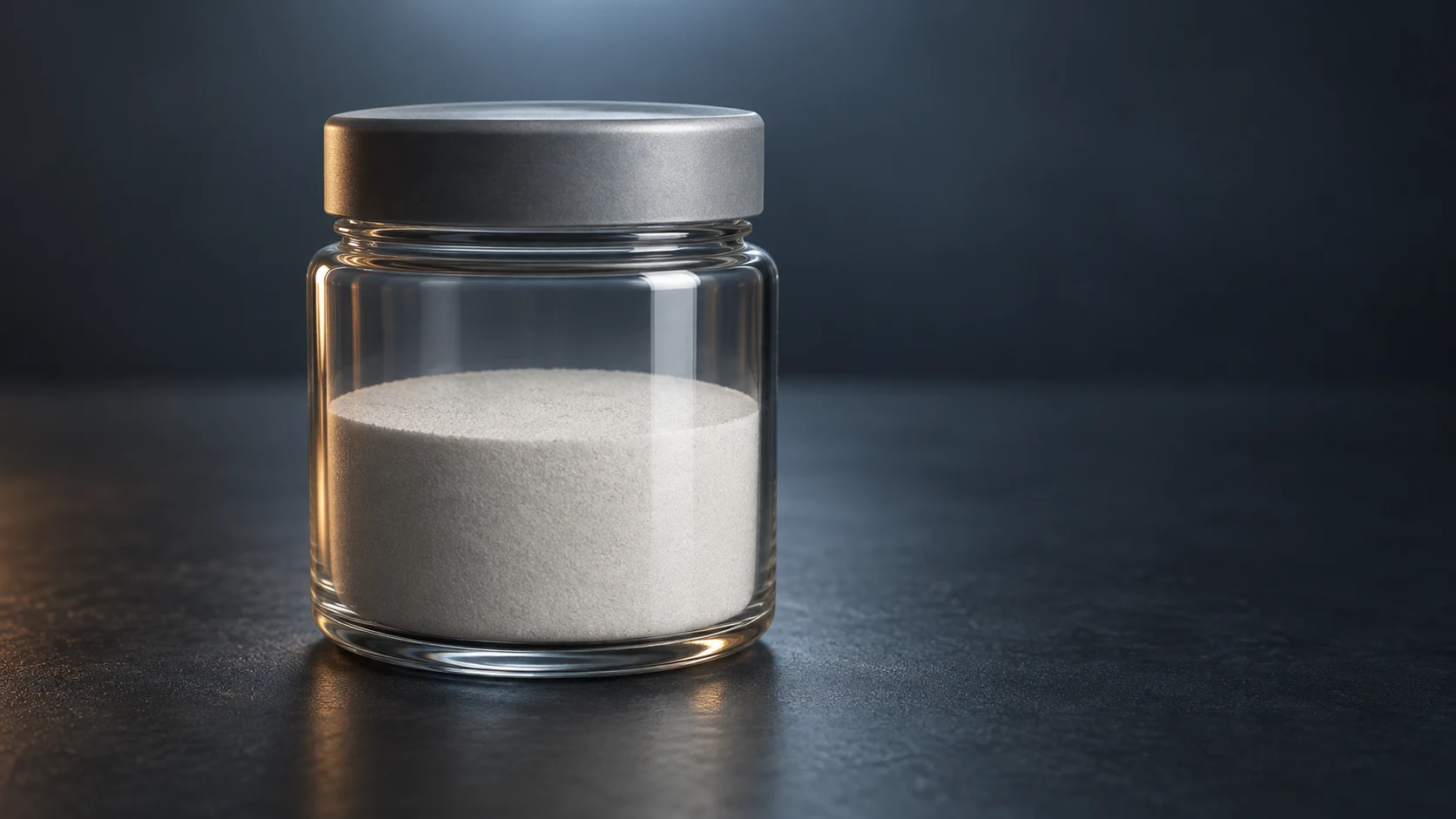 Conceptual image of a plain stoppered glass jar of fine pale grey-white powder on a dark surface