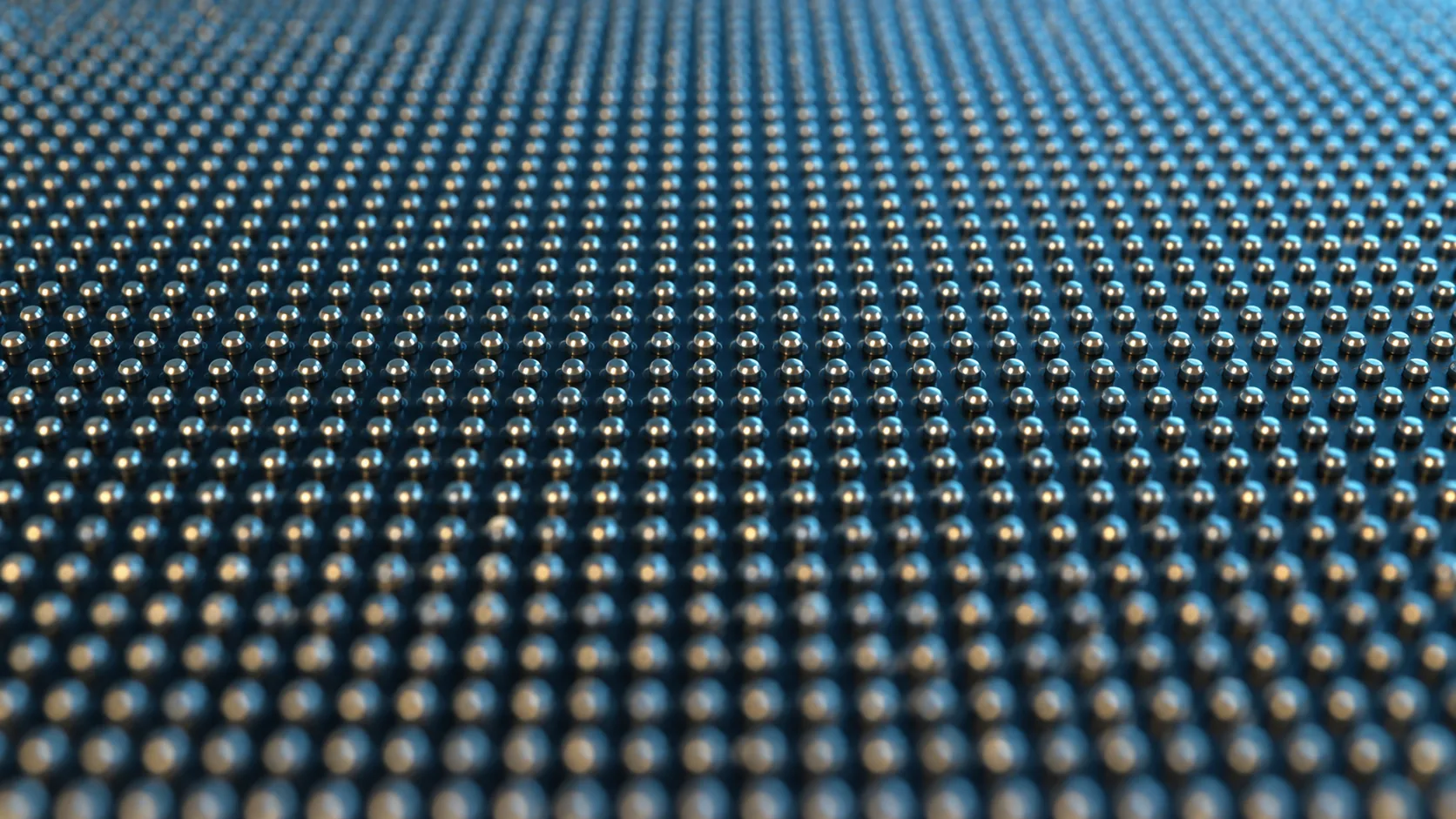 Conceptual image of fine metal bumps in a grid covering the entire underside of a large semiconductor chip, receding into the distance