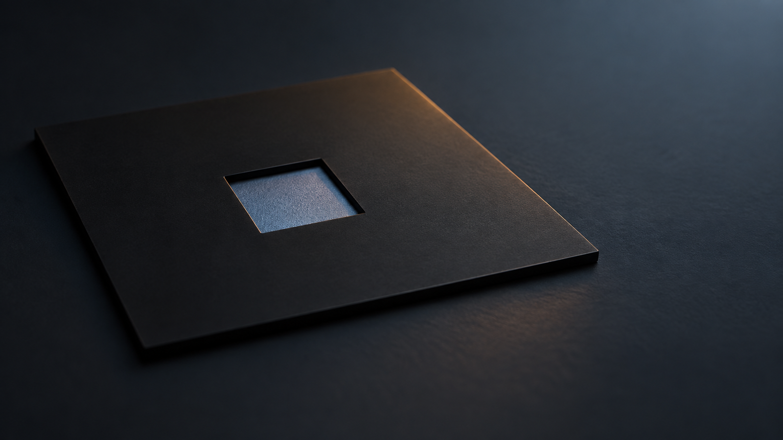 Conceptual image of even light falling on a small dark plate through a square opening cut in a plain black sheet, against a dark background