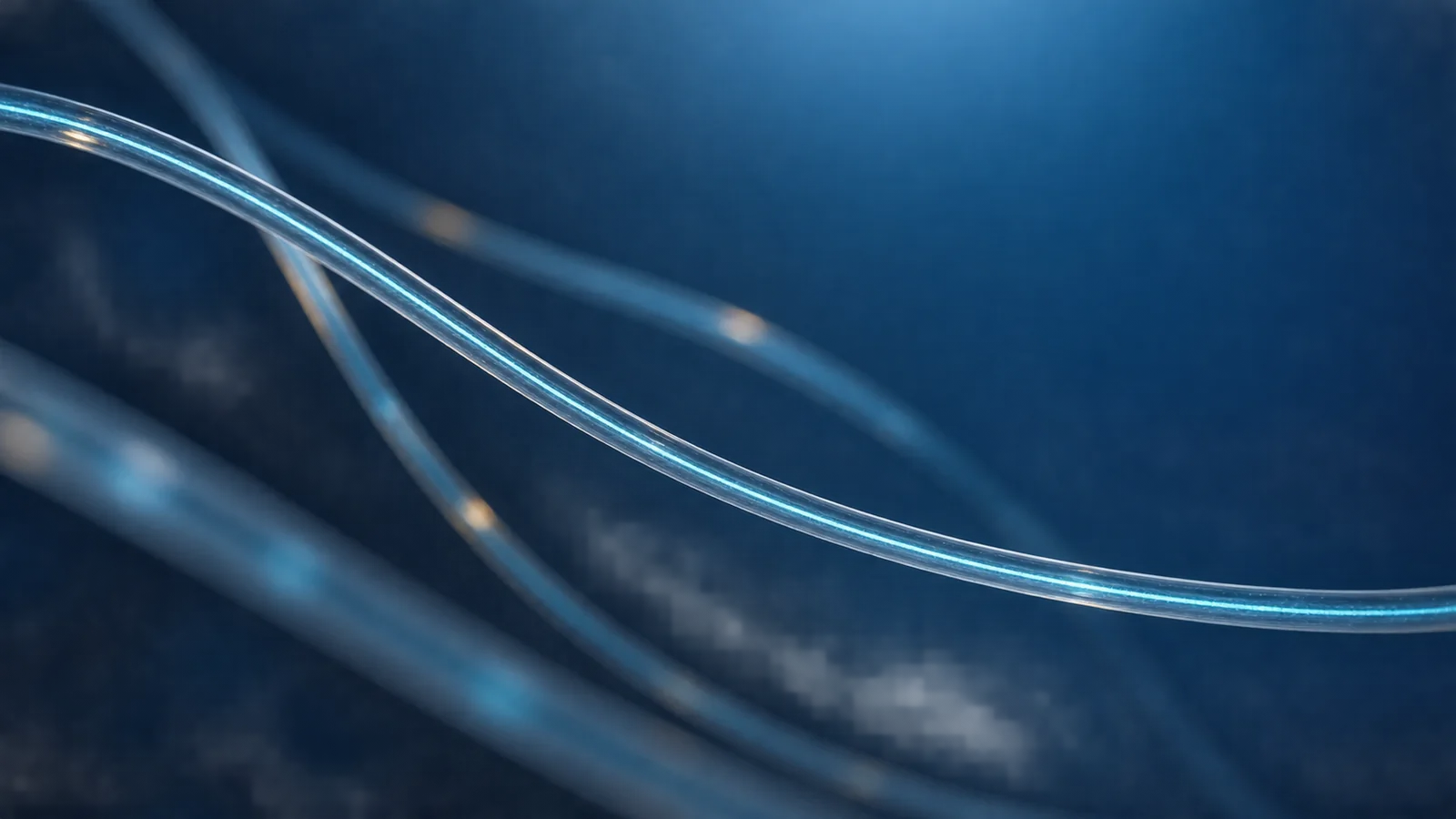Conceptual image of a transparent fiber as thin as a hair tracing a gentle curve against a dark background, with faint light travelling inside it