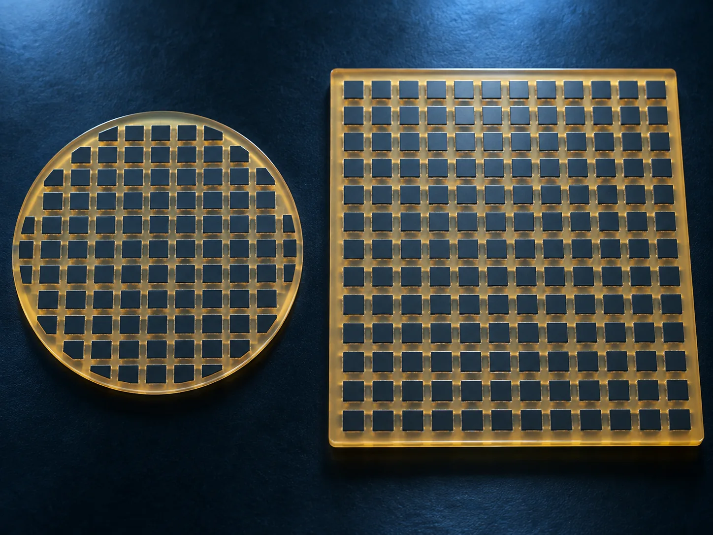 Conceptual image of a round wafer and a square panel side by side, each carrying a grid of package sites