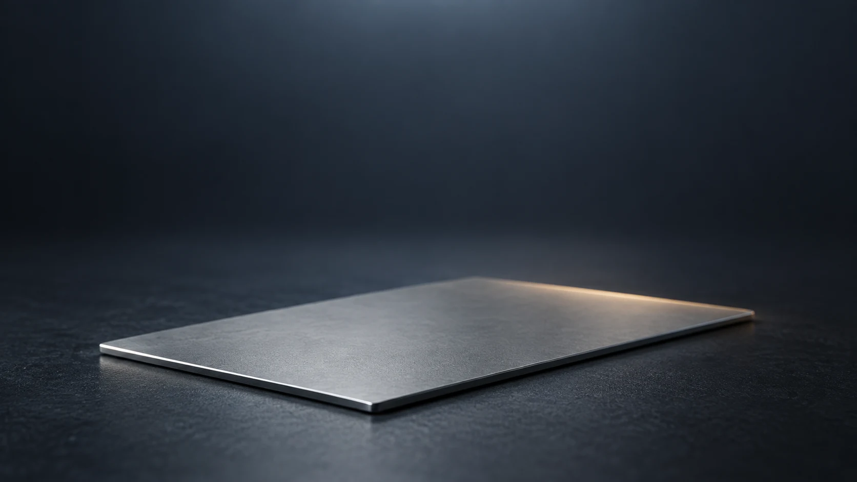 Conceptual image of a single thin flat metal sheet on a dark surface with nothing resting on it
