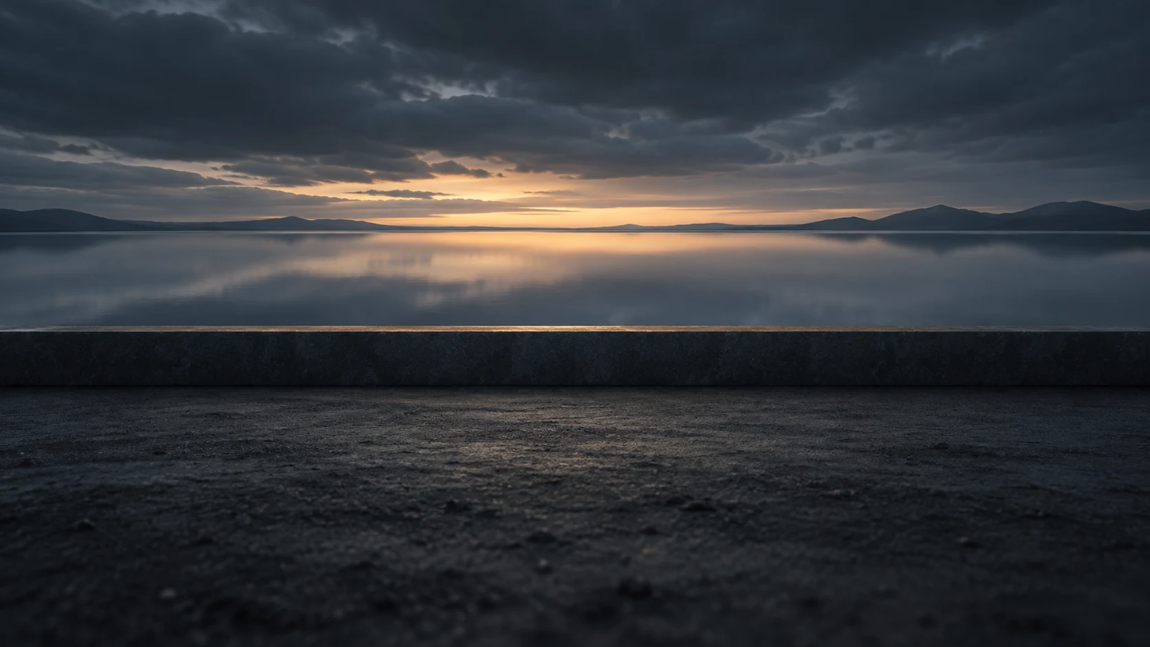 Spare abstract conceptual image of a low straight dyke holding back still water under a dark sky