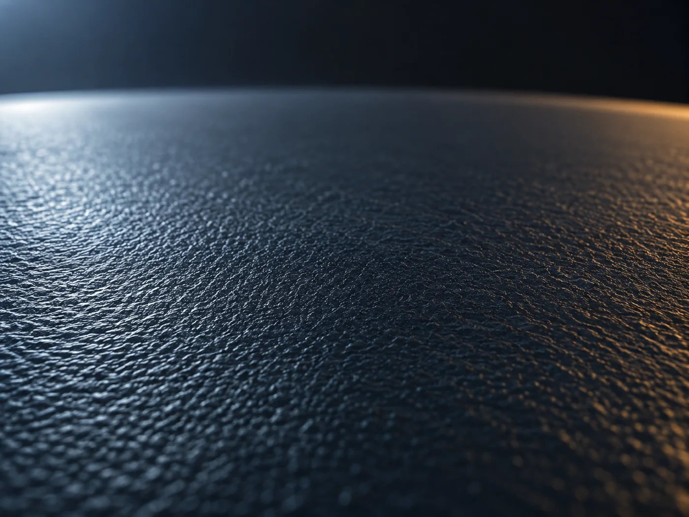 Conceptual image of a flat dark navy plate against a dark background, its fine, uniform glossy texture picked out by raking light