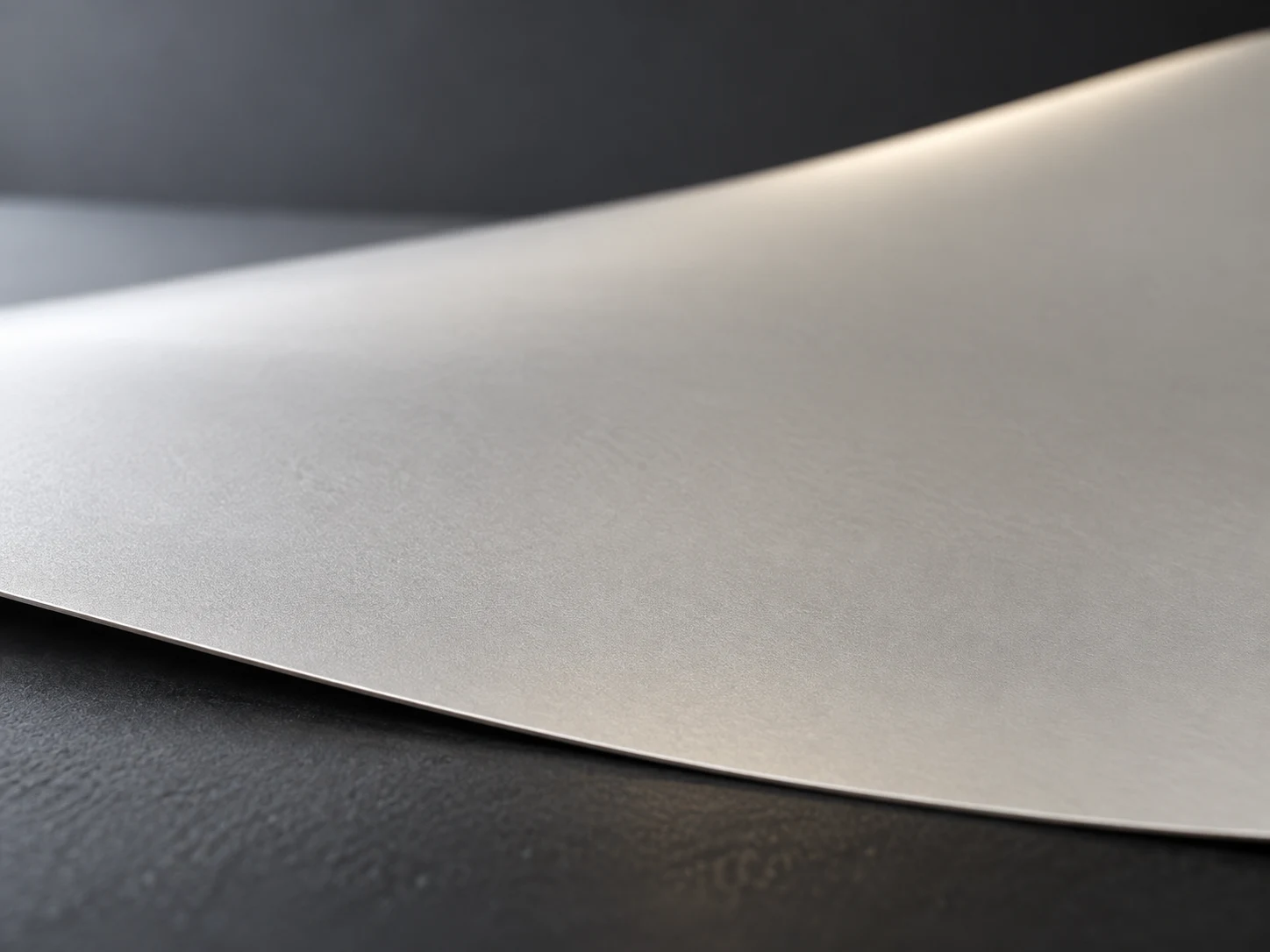 Conceptual image of a pale powder rolled thin and even into a film resting with a slight sag on a support