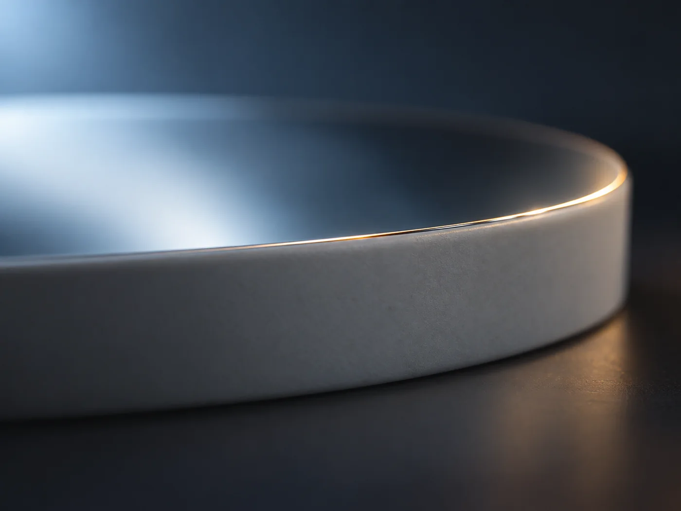 Conceptual image against a dark background of the edge of an extremely thin transparent layer on a thick substrate, catching low-angle light as a fine bright line