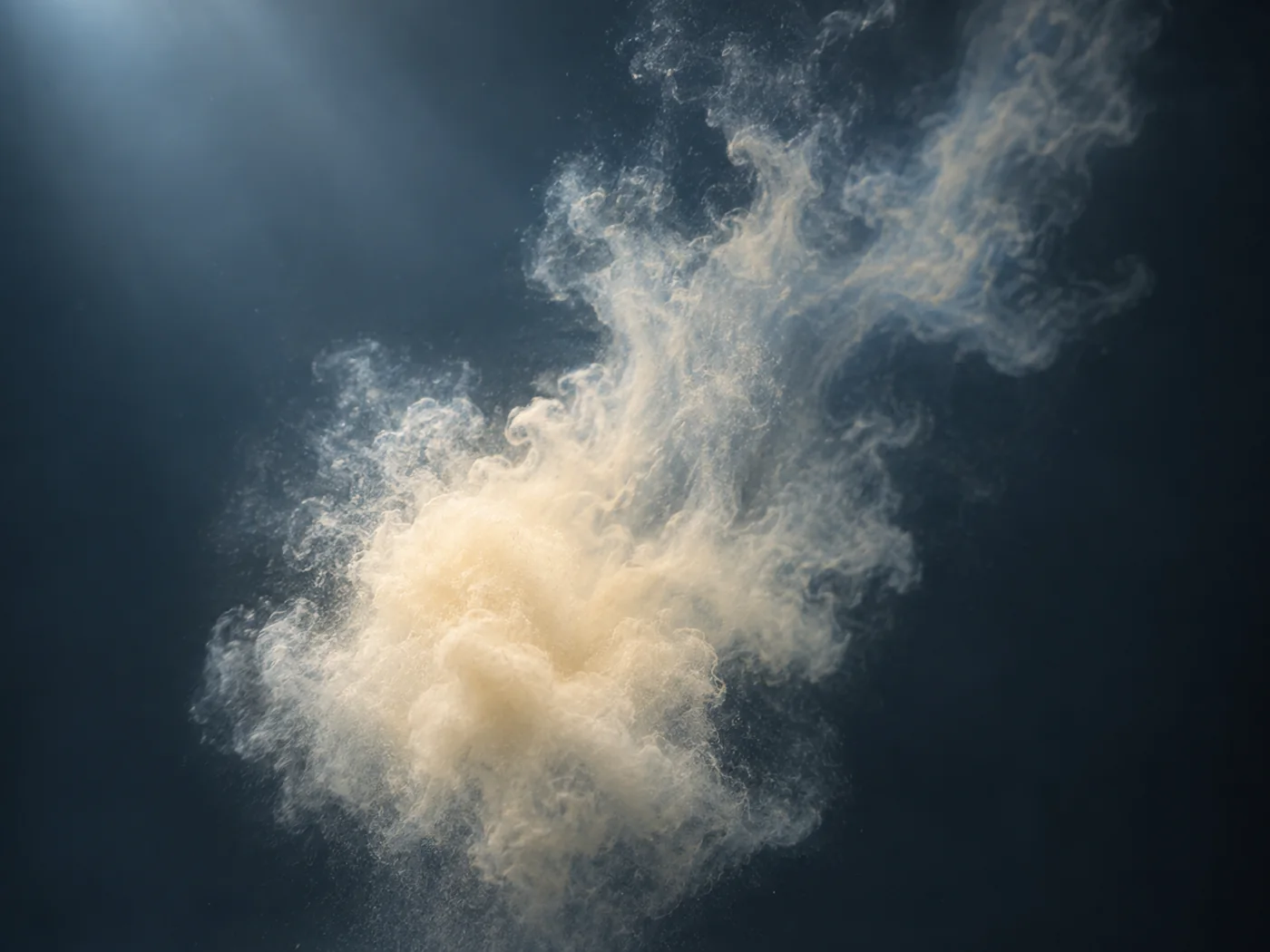 In a transparent water, a collection of fine grains of light colors spreads slowly, and an abstract concept image that swells